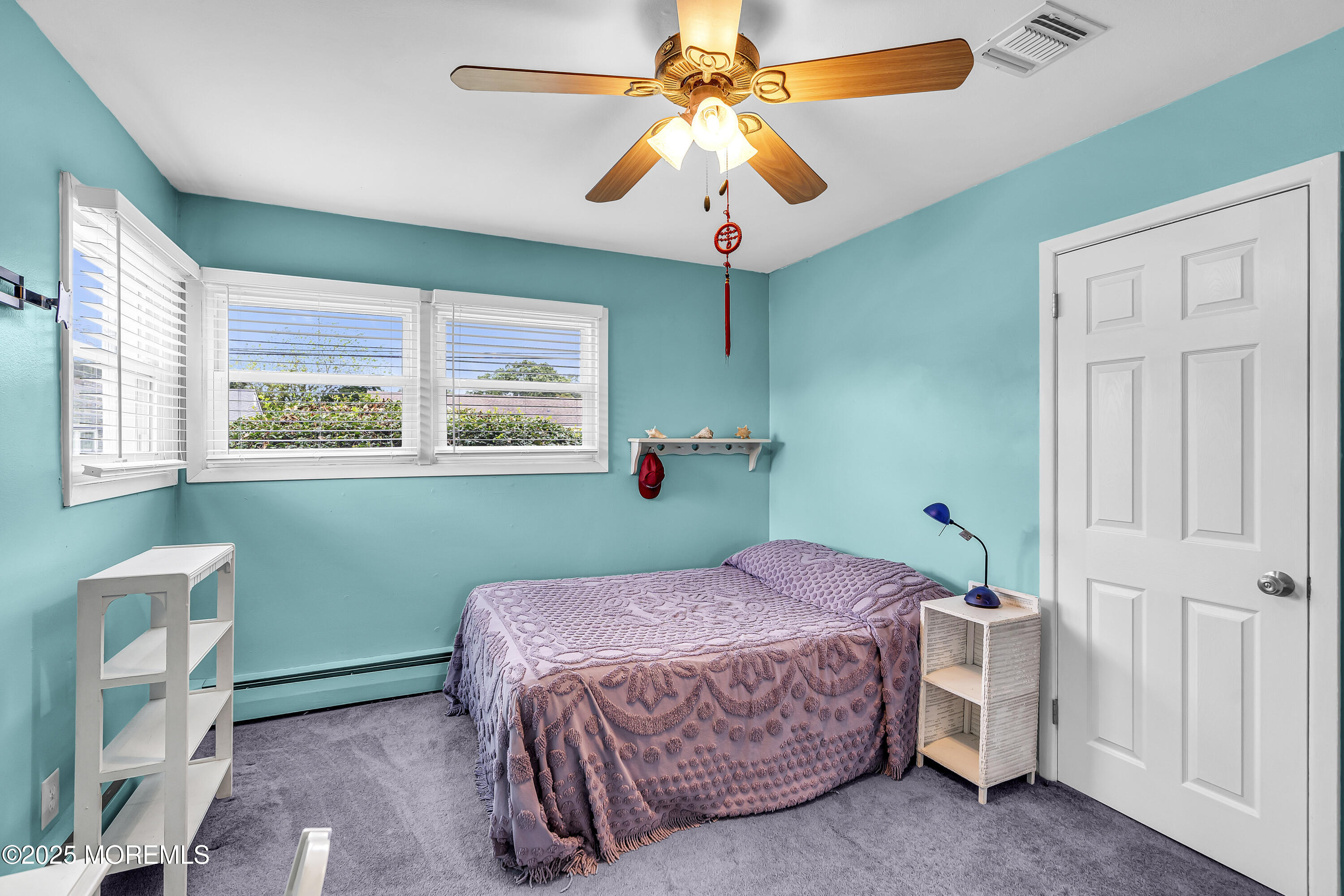 1400 Treeneedle Road Point Pleasant, NJ 08742 - Photo 29 of 45 a bedroom with a bed and a chandelier
