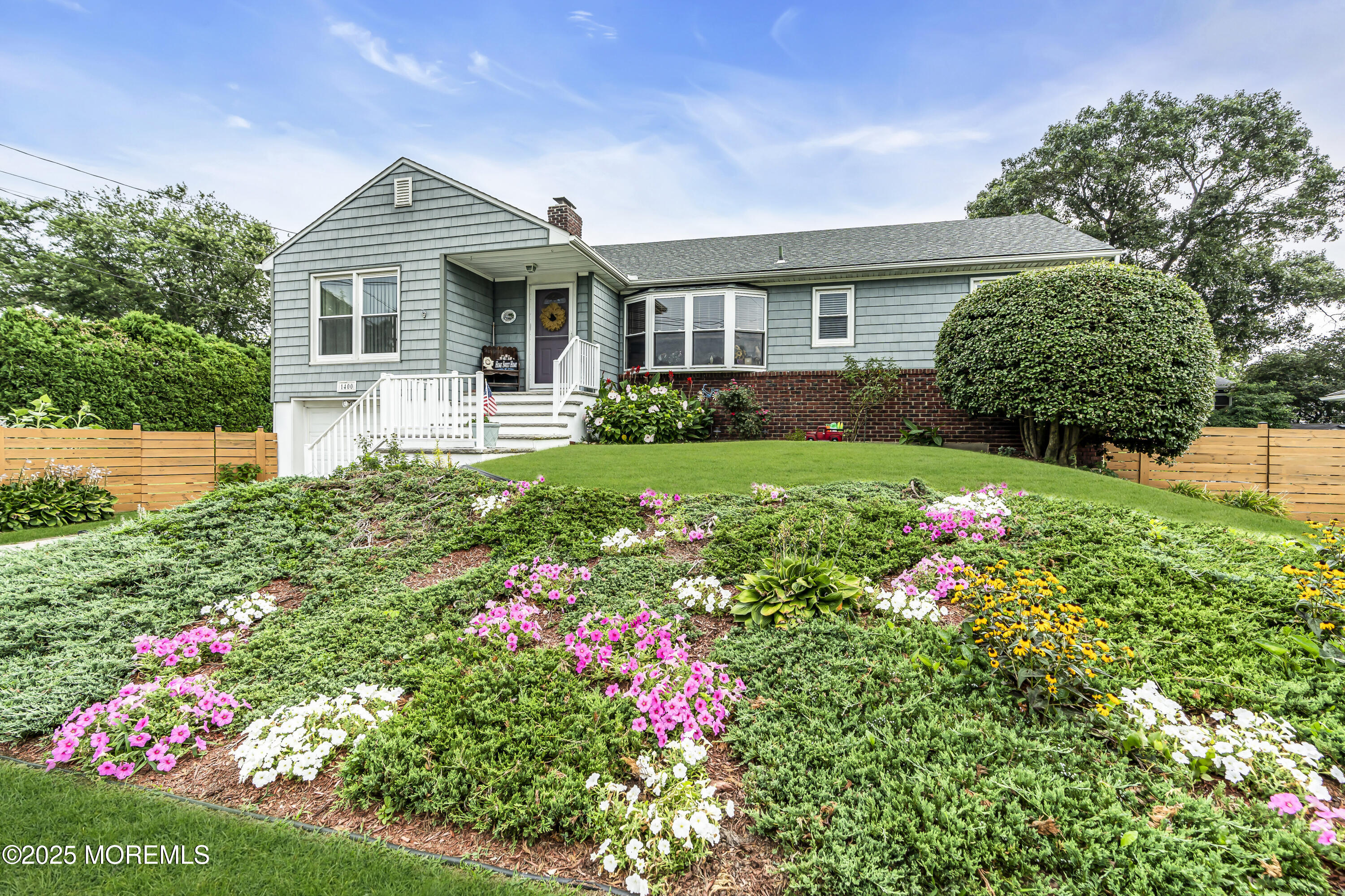1400 Treeneedle Road Point Pleasant, NJ 08742 - Photo 3 of 45 a front view of a house with a big yard and potted plants