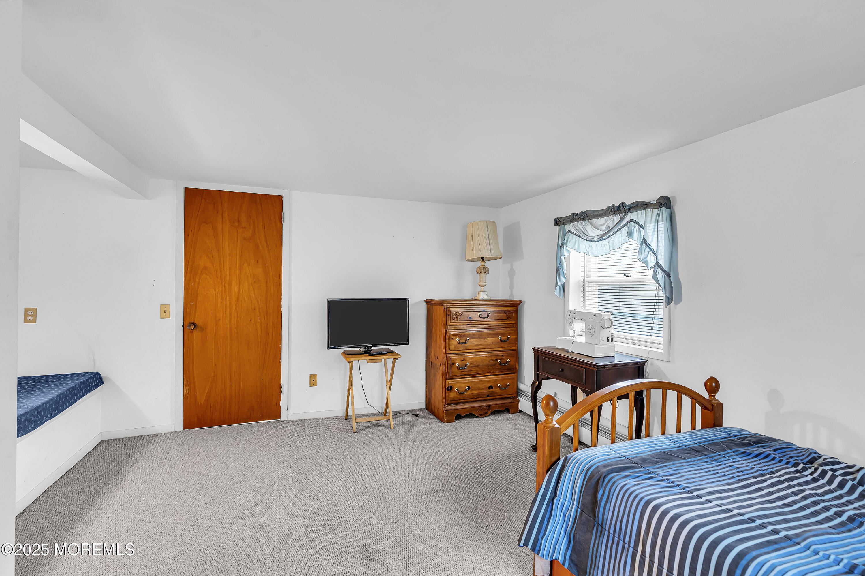 1400 Treeneedle Road Point Pleasant, NJ 08742 - Photo 33 of 45 a bedroom with a bed and a flat screen tv