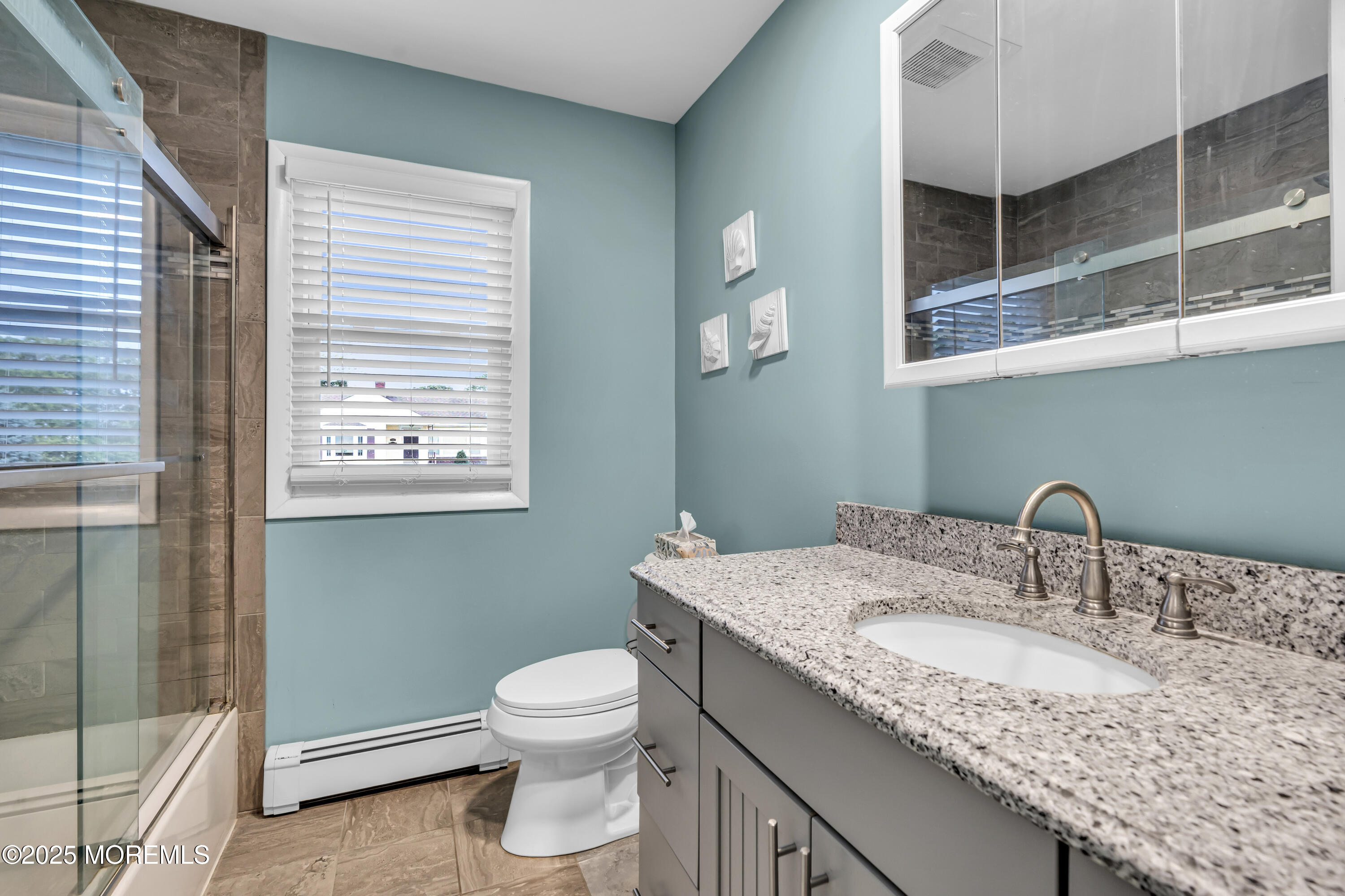 1400 Treeneedle Road Point Pleasant, NJ 08742 - Photo 38 of 45 a bathroom with a granite countertop sink a toilet and a mirror