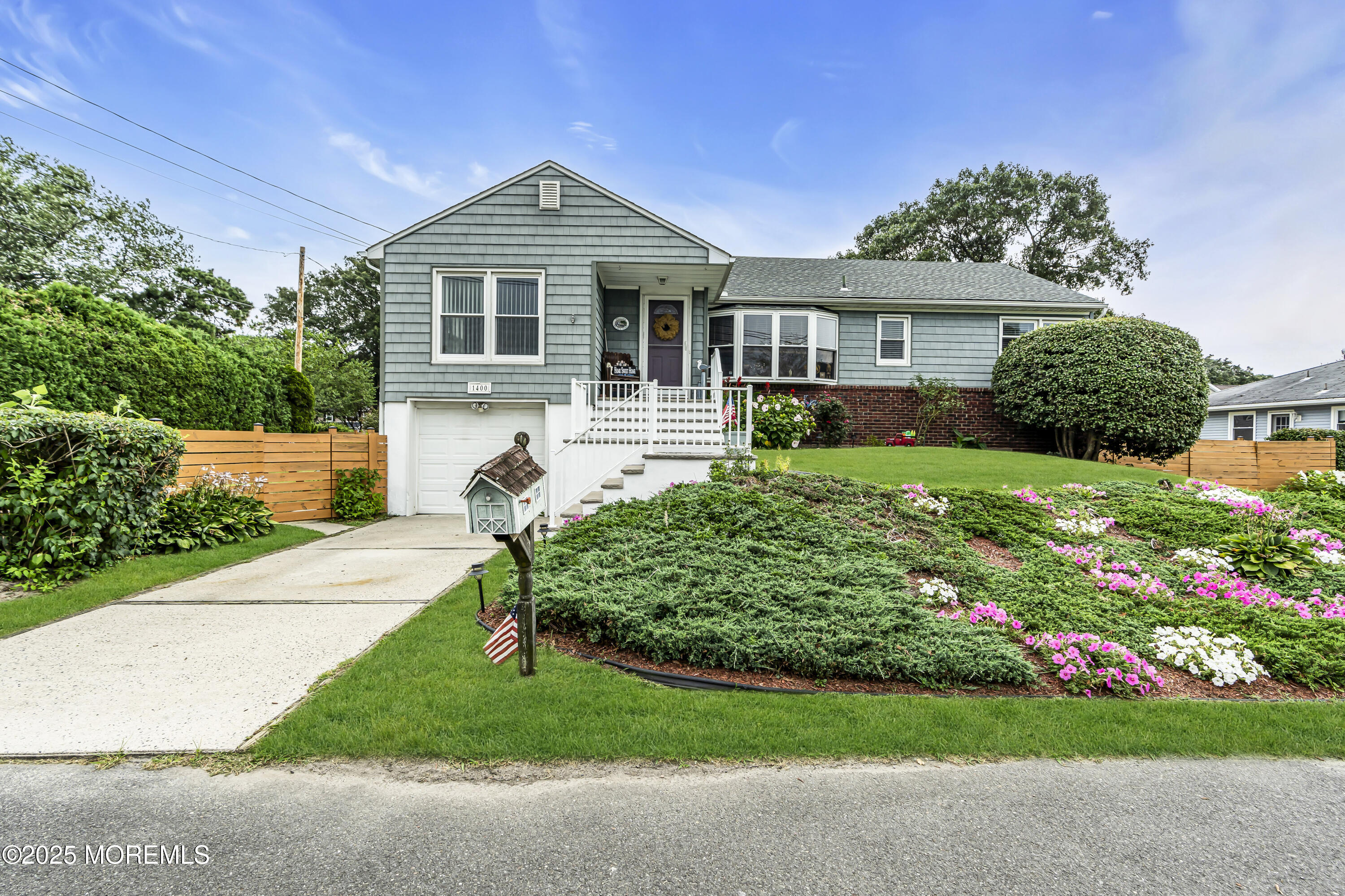 1400 Treeneedle Road Point Pleasant, NJ 08742 - Photo 6 of 45 a front view of a house with a garden