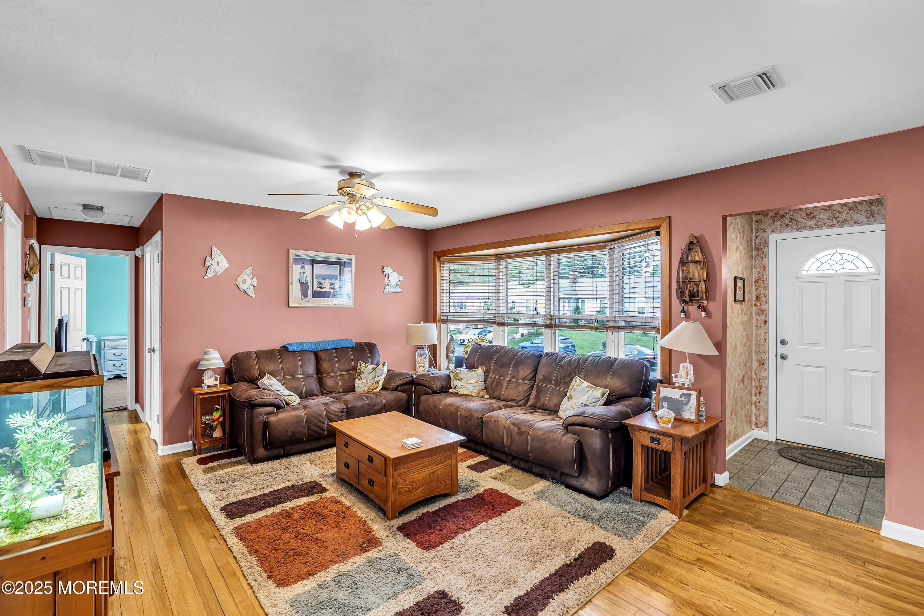 1400 Treeneedle Road Point Pleasant, NJ 08742 - Photo 10 of 45 a living room with furniture a rug and a floor to ceiling window