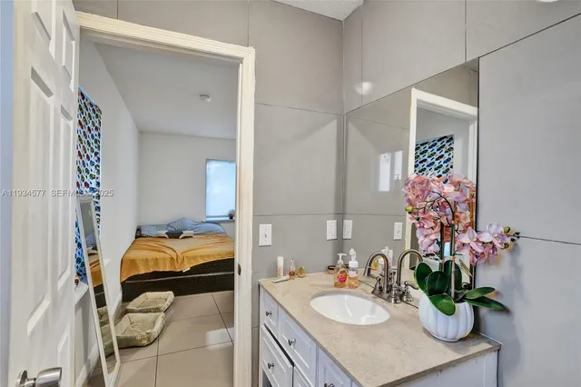 a bathroom with a sink mirror and vanity