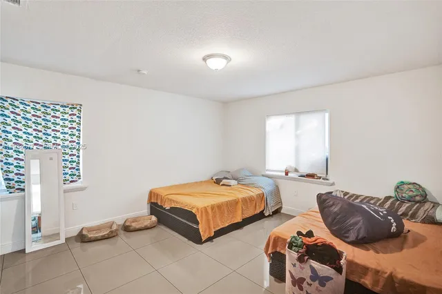 a bedroom with two beds and a window