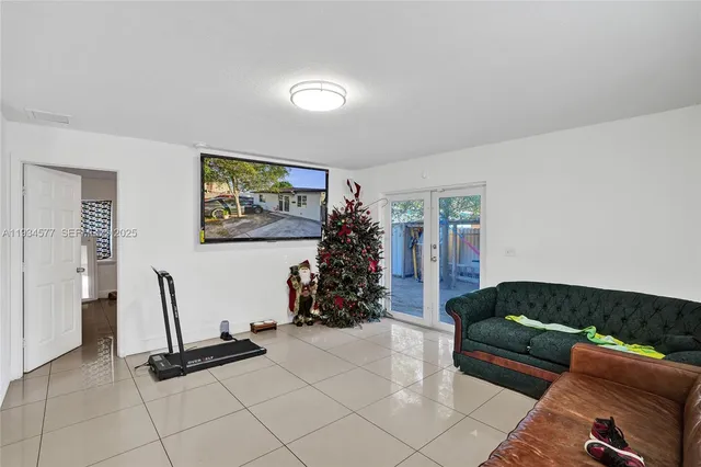 a living room with furniture gym equipment and a chandelier