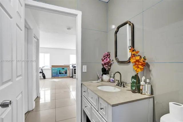 a bathroom with a sink vanity granite and a mirror