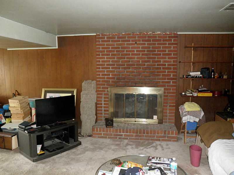 1432 Spring Run Road Extension Coraopolis, PA 15108 - Photo 24 of 25 Family Room. Brick front log burning fireplace in the lower level family room. Walk out through sliding glass doors to the rear yard.