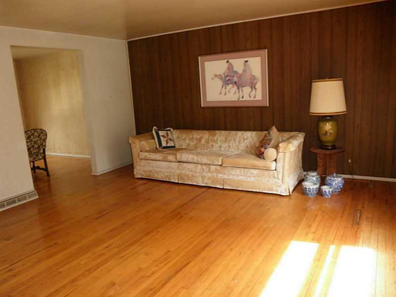 1432 Spring Run Road Extension Coraopolis, PA 15108 - Photo 10 of 25 Living Room. Spacious living room has hardwood floors. Some damage in one corner to wood floors.
