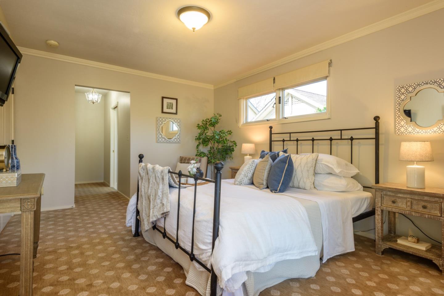 132 Bancroft Road Burlingame, CA 94010 - Photo 16 of 27 a bedroom with a bed a mirror on dresser and a table