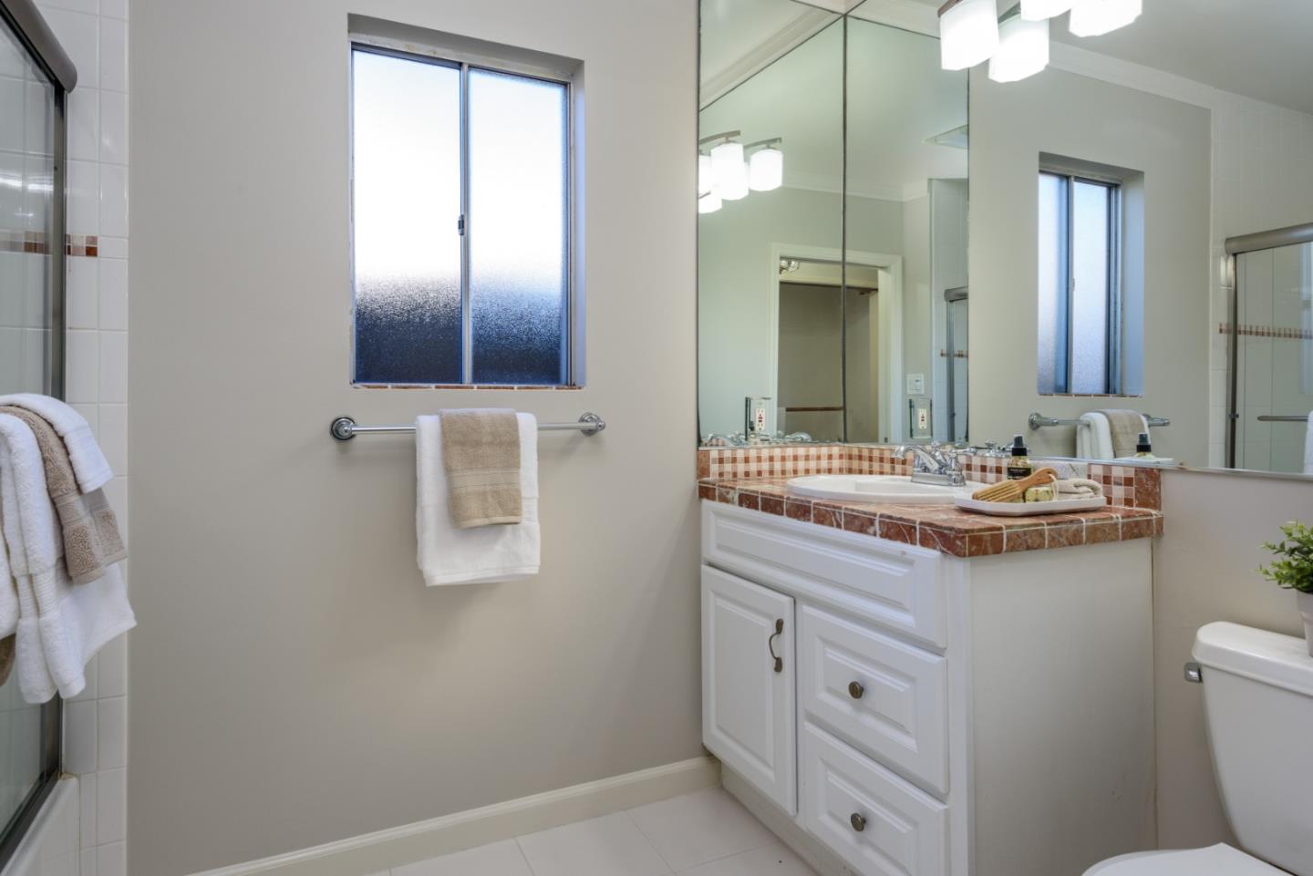 132 Bancroft Road Burlingame, CA 94010 - Photo 17 of 27 a bathroom with a granite countertop sink a toilet and a mirror