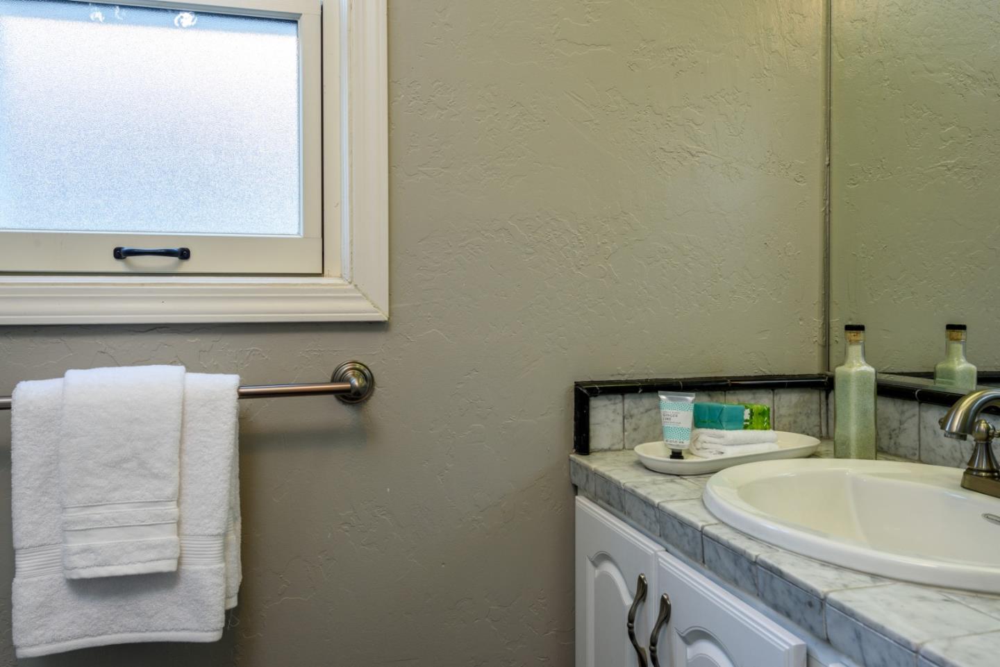 132 Bancroft Road Burlingame, CA 94010 - Photo 20 of 27 a bathroom with a sink and a mirror