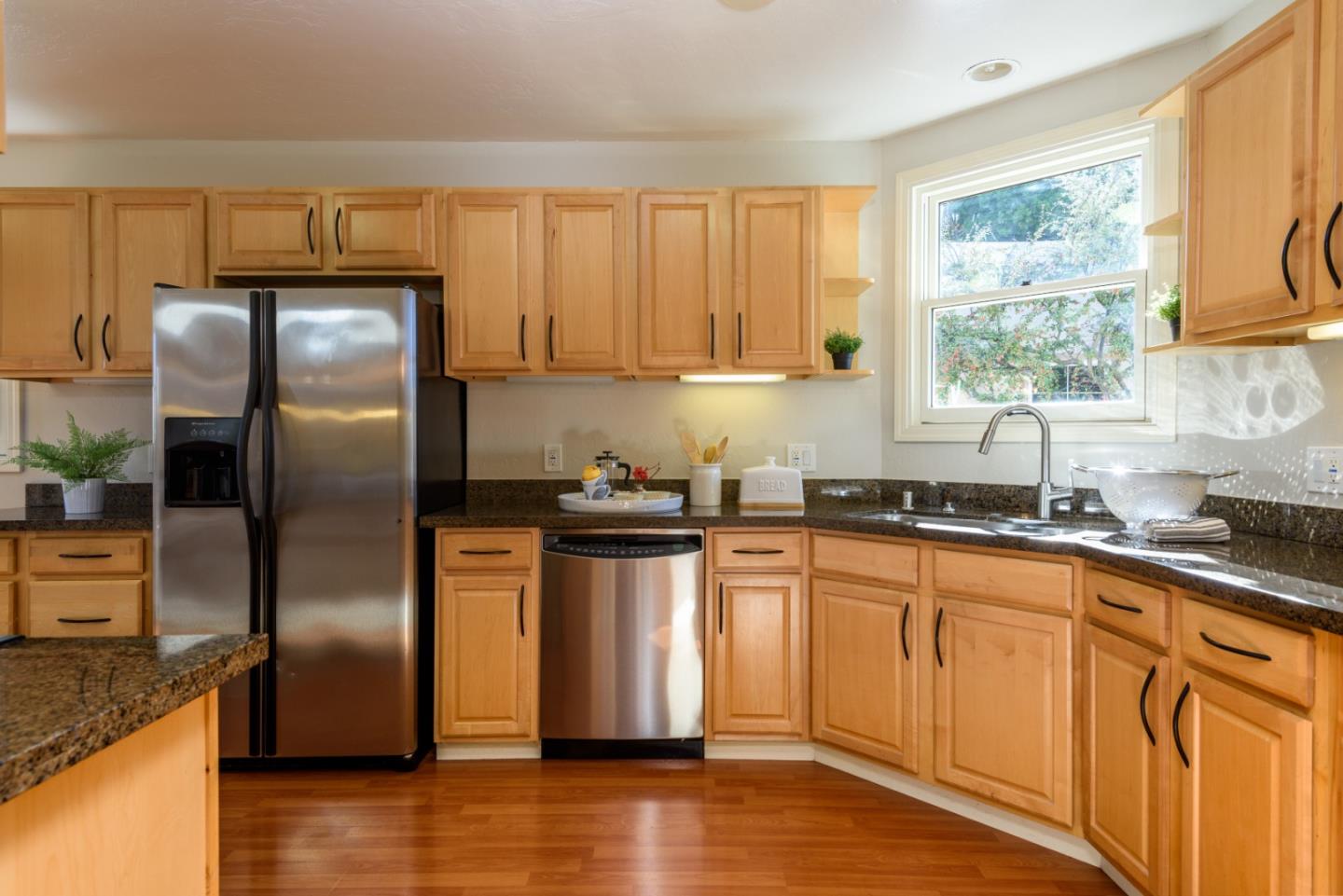132 Bancroft Road Burlingame, CA 94010 - Photo 5 of 27 a kitchen with granite countertop stainless steel appliances a sink a refrigerator a window and cabinets