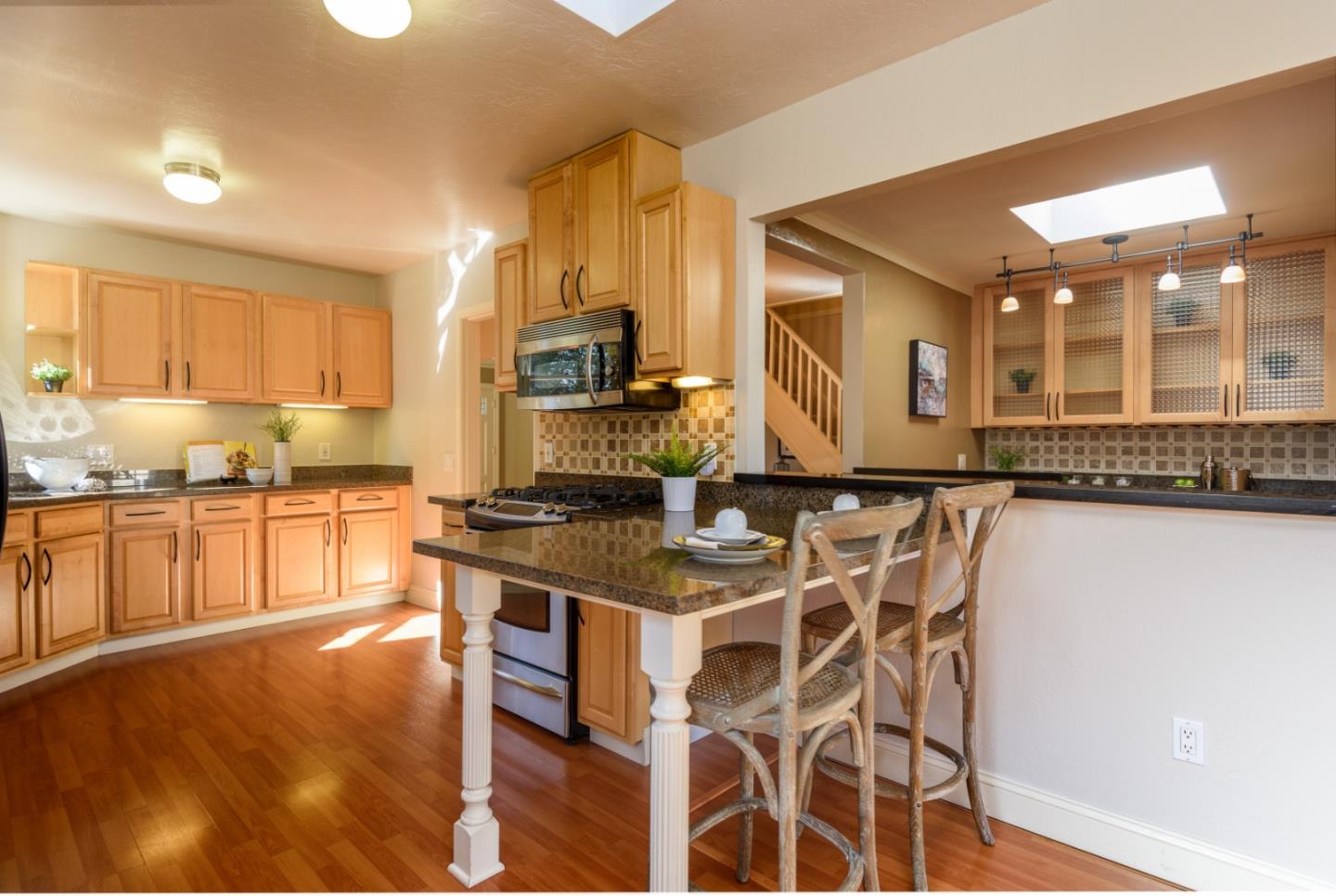 132 Bancroft Road Burlingame, CA 94010 - Photo 6 of 27 a kitchen with stainless steel appliances granite countertop a stove a sink and a microwave