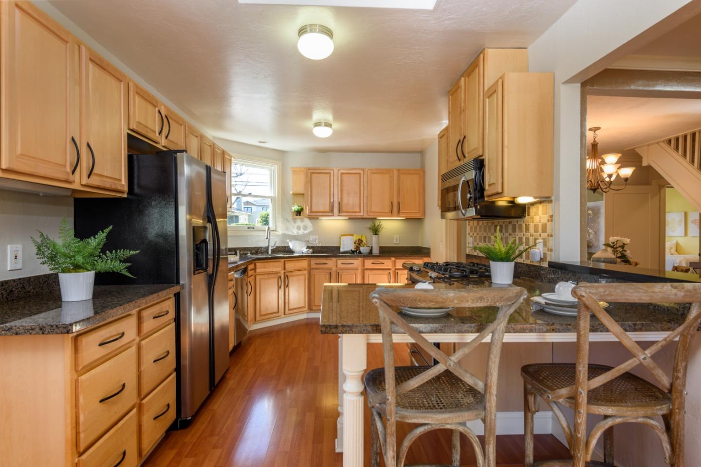 132 Bancroft Road Burlingame, CA 94010 - Photo 7 of 27 a kitchen with kitchen island granite countertop lots of counter top space and stainless steel appliances