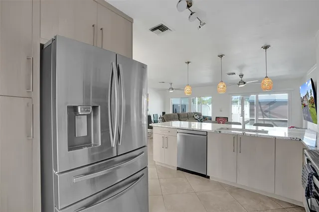 a kitchen with stainless steel appliances a refrigerator and a stove