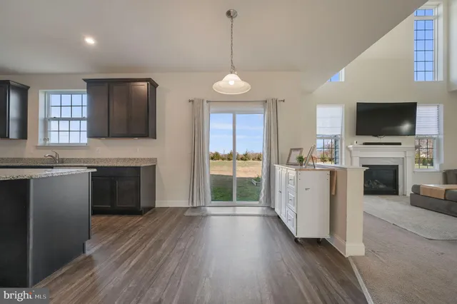 a view of a kitchen with a sink wooden floor and a window