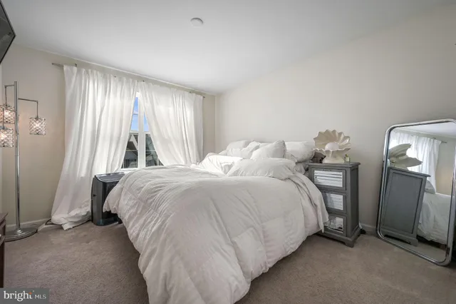 a bedroom with a bed and a mirror