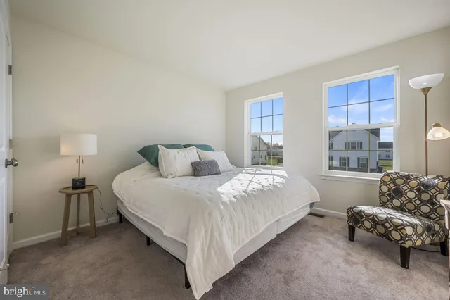 a bedroom with a bed and a couch