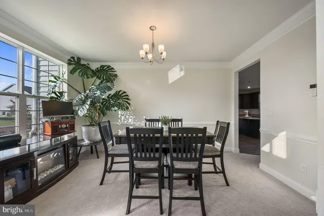 a view of a dining room with furniture and chandelier