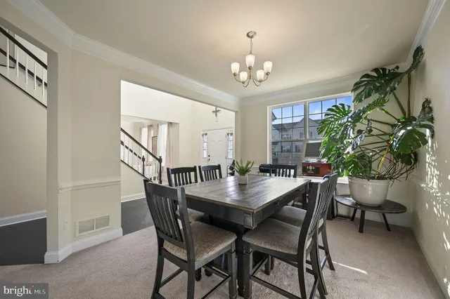 a view of a dining room with furniture and a chandelier