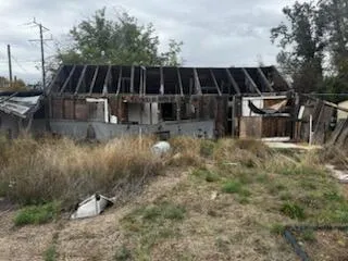 a view of house with backyard and seating space