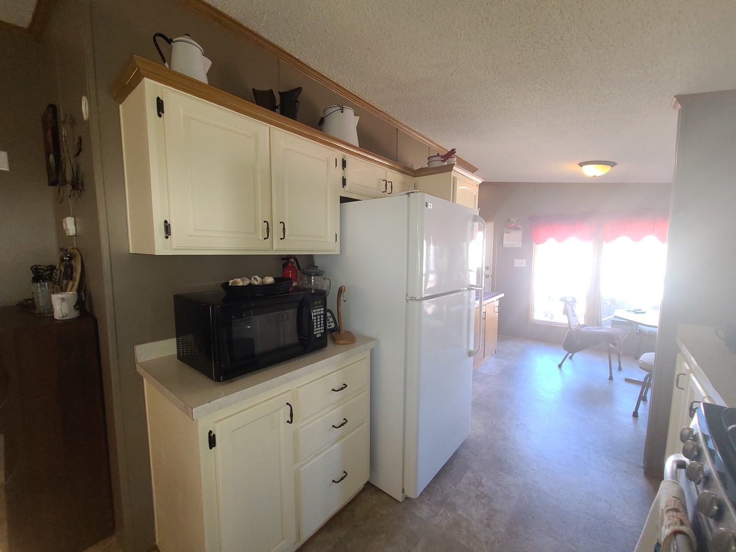 291 Highway 2, Unit 49 Dixon, IL 61021 - Photo 11 of 28 a kitchen with a refrigerator and a stove