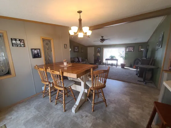 a view of a dining room with furniture and a chandelier