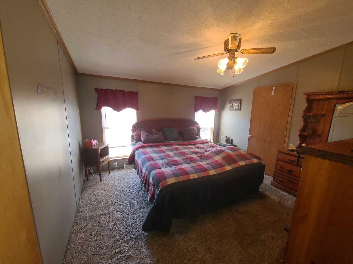291 Highway 2, Unit 49 Dixon, IL 61021 - Photo 19 of 28 a spacious bedroom with a bed and a chandelier