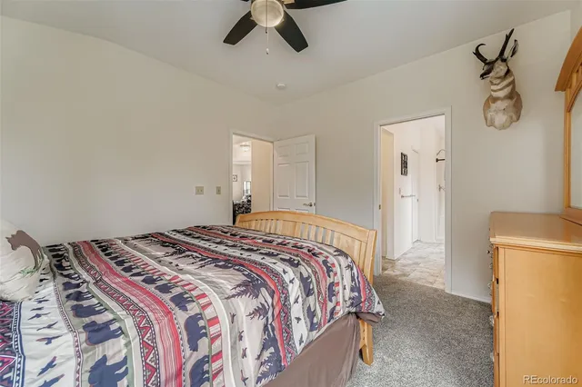 a bedroom with a bed and a refrigerator