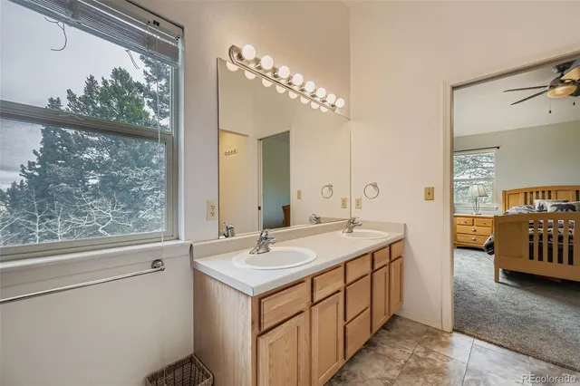 a bathroom with a sink a mirror and a window