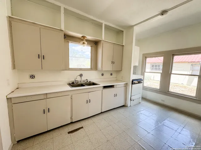 a spacious bathroom with a double vanity sink a mirror and a bathtub