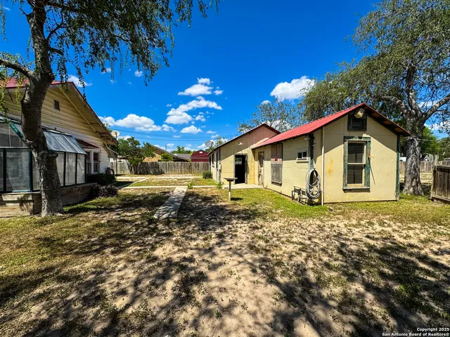 a view of a backyard with sitting area