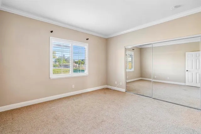 an empty room with windows and closet