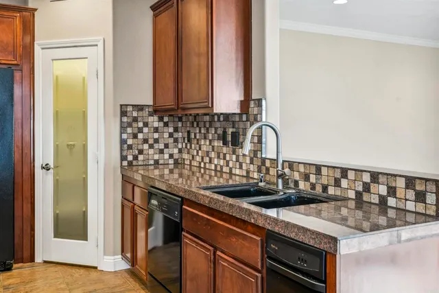 a kitchen with granite countertop a sink and a stove