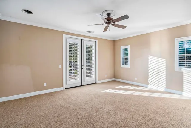 a view of a livingroom with a ceiling fan and window