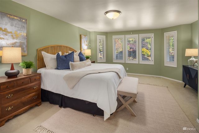 a bedroom with a large bed and a window