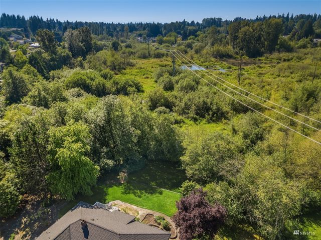 a view of a city with lush green forest