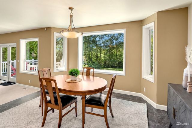 a dining room with furniture window and outside view