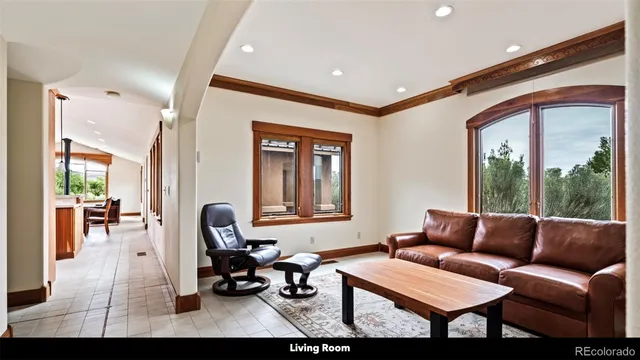 a living room with furniture a rug and a table