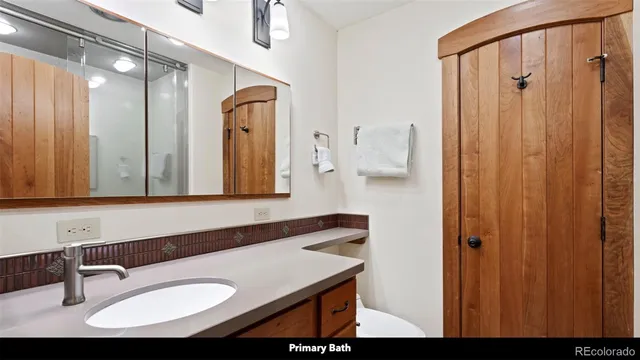 a kitchen with stainless steel appliances granite countertop a sink a stove a refrigerator with grey cabinets