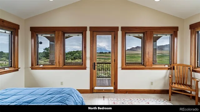 a bedroom with a bed and glass window