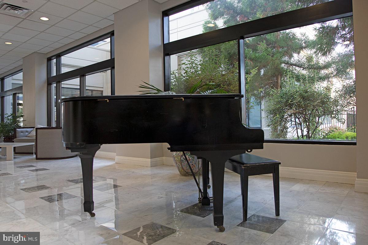 2001 Hamilton Street, Unit 1523 Philadelphia, PA 19130 - Photo 16 of 17 a living room with a chair tables and a large window