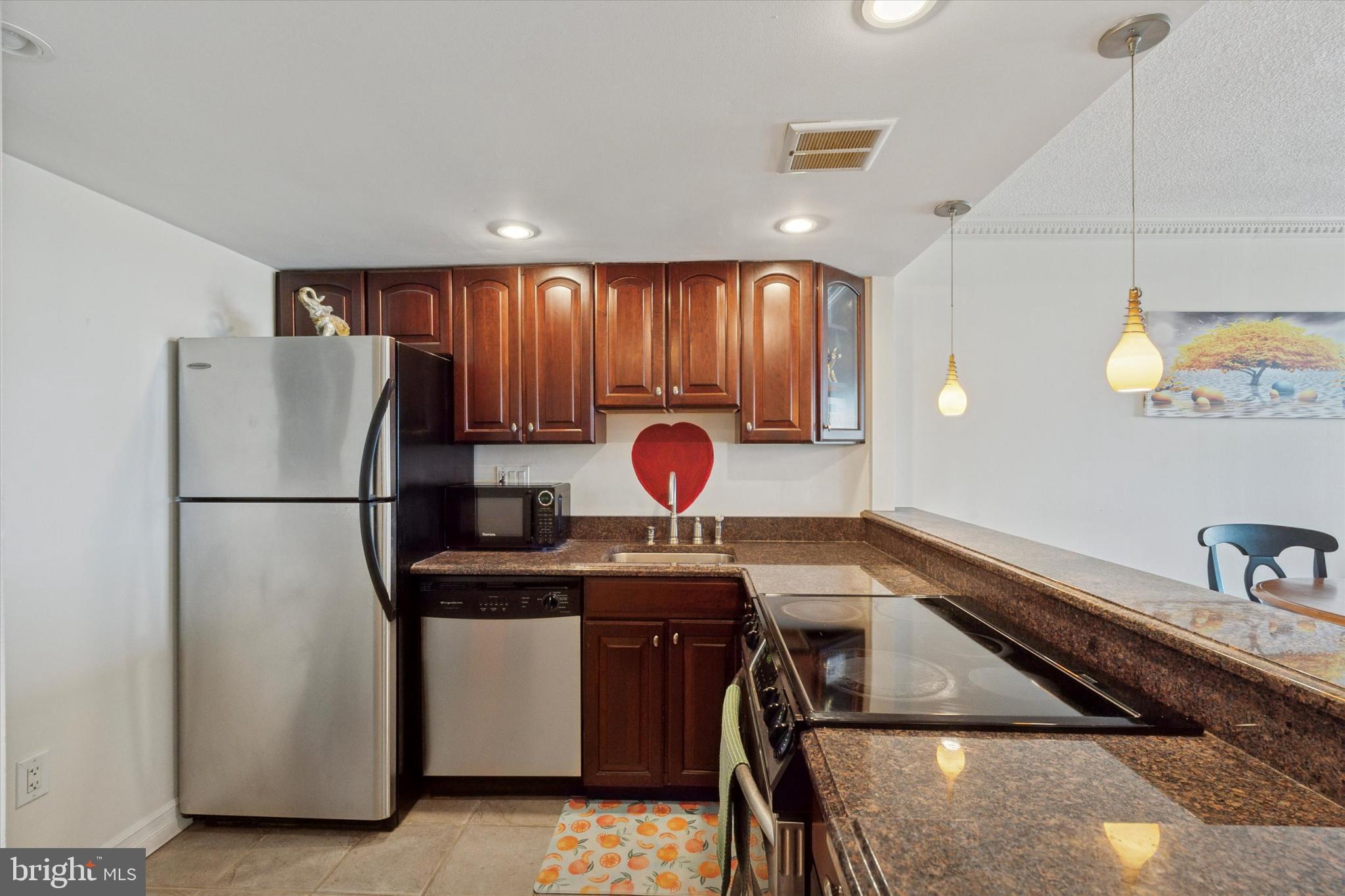 2001 Hamilton Street, Unit 1523 Philadelphia, PA 19130 - Photo 3 of 17 a kitchen with stainless steel appliances granite countertop a sink a refrigerator and a stove