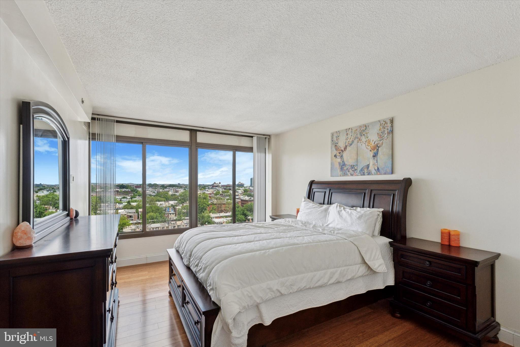 2001 Hamilton Street, Unit 1523 Philadelphia, PA 19130 - Photo 7 of 17 a bedroom with a bed and a large window with outer view
