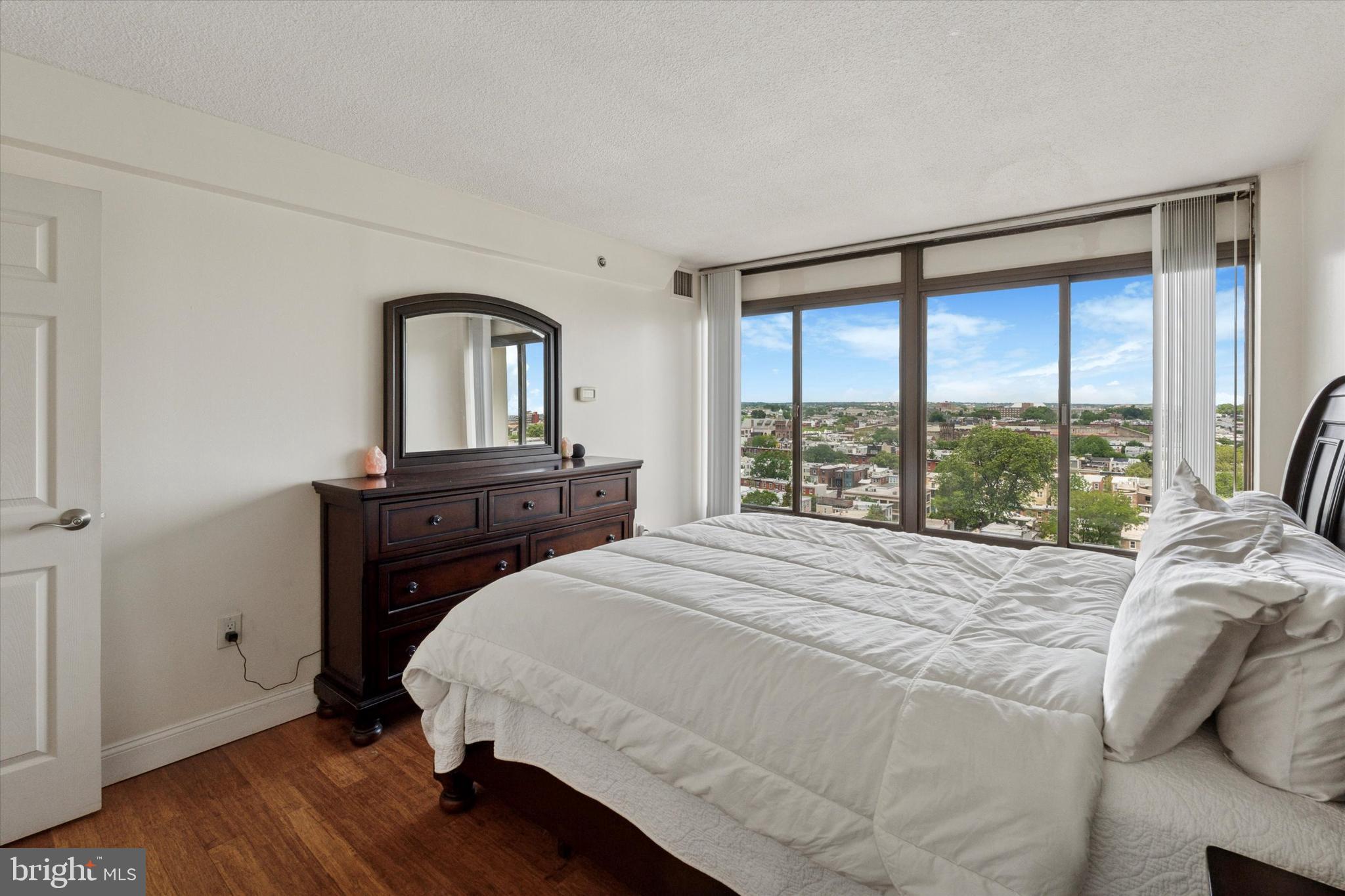 2001 Hamilton Street, Unit 1523 Philadelphia, PA 19130 - Photo 8 of 17 a bedroom with a bed and a large window