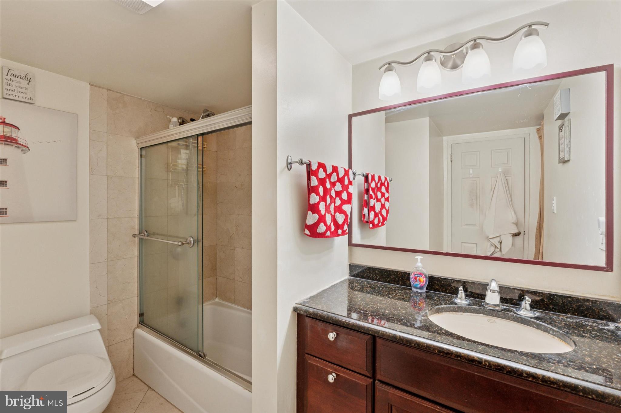 2001 Hamilton Street, Unit 1523 Philadelphia, PA 19130 - Photo 10 of 17 a bathroom with a granite countertop sink shower and a mirror