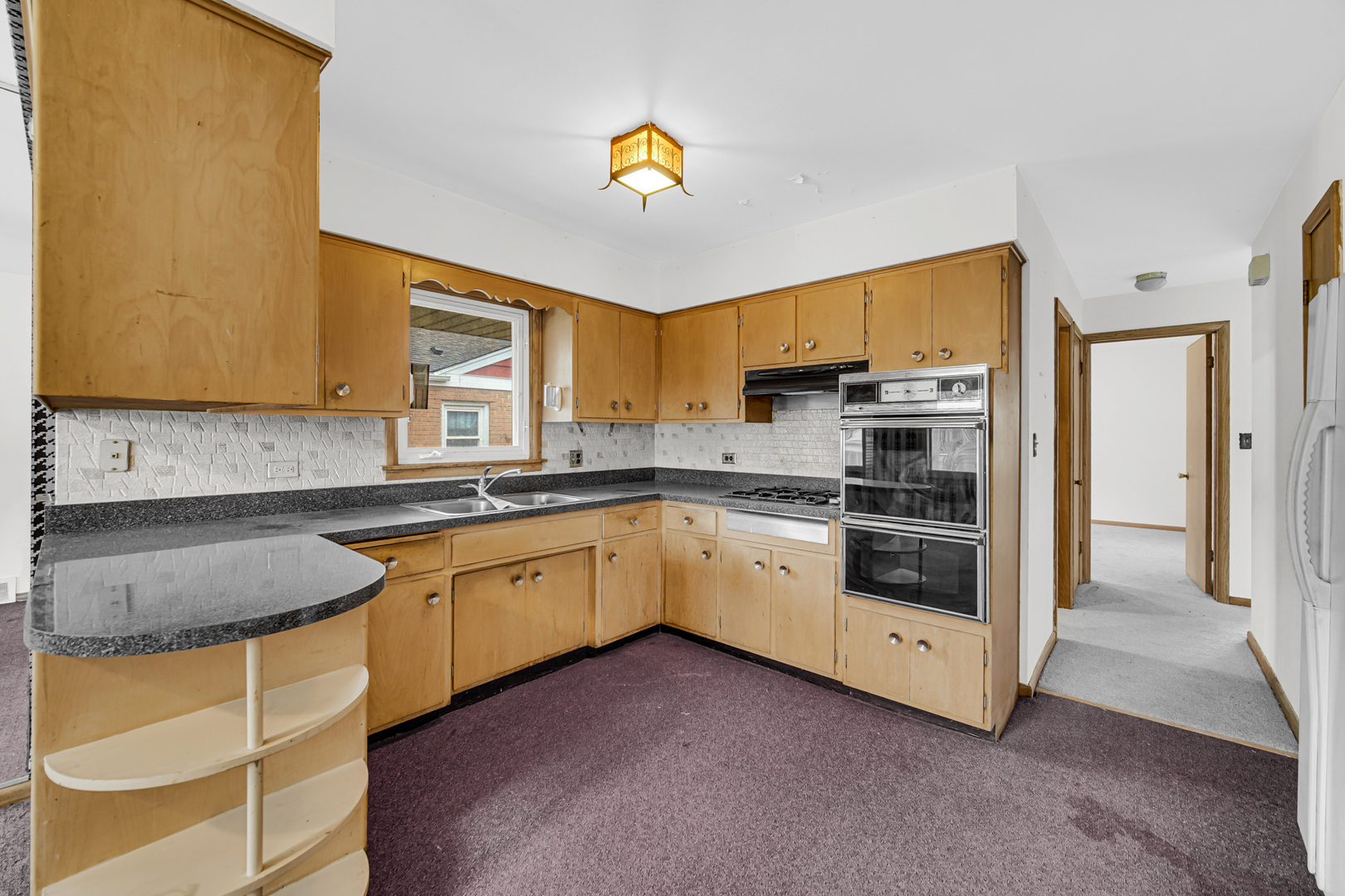 901 Oakton Street Park Ridge, IL 60068 - Photo 11 of 22 a kitchen with stainless steel appliances granite countertop a stove a sink and a refrigerator