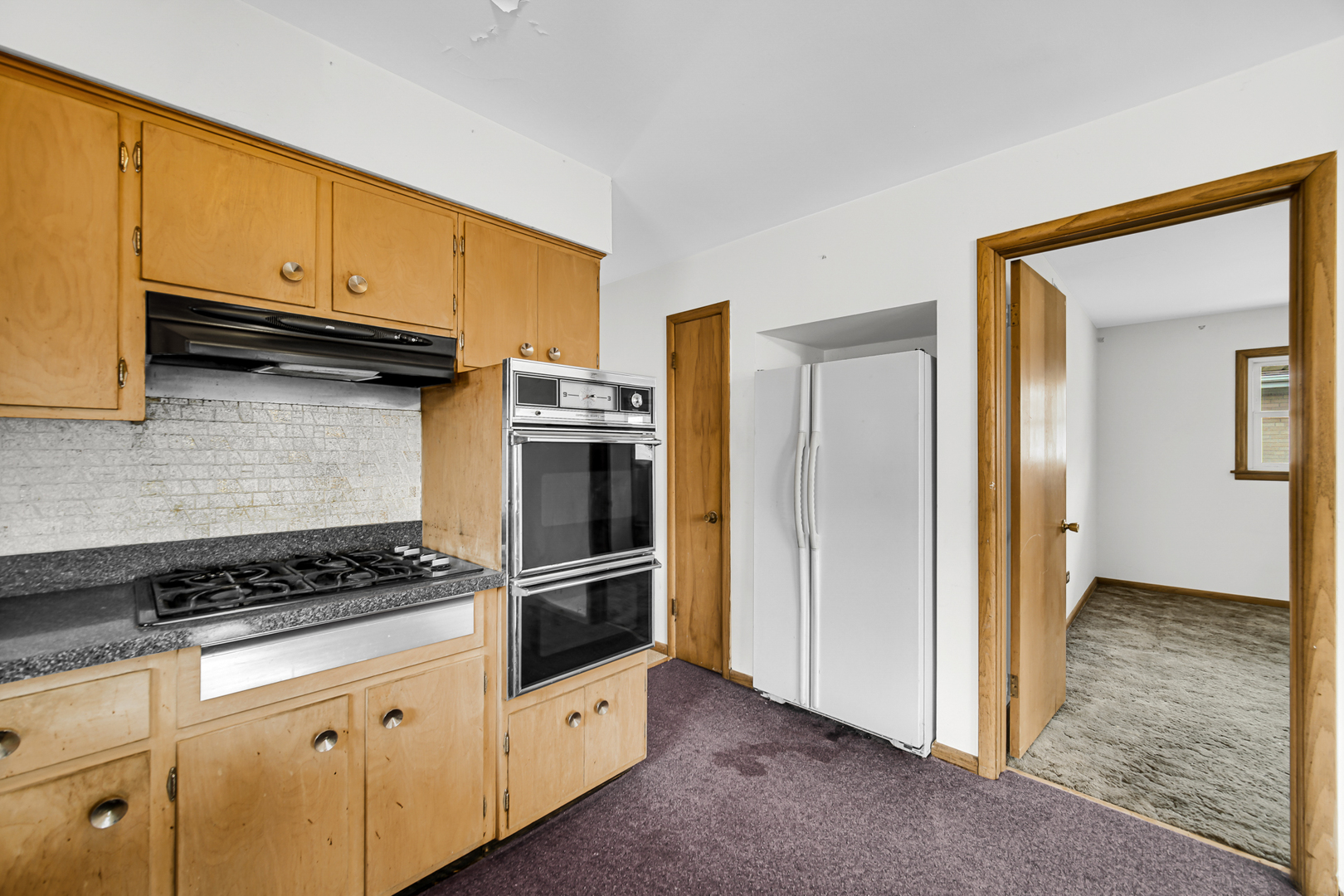 901 Oakton Street Park Ridge, IL 60068 - Photo 12 of 22 a kitchen with white cabinets and appliances