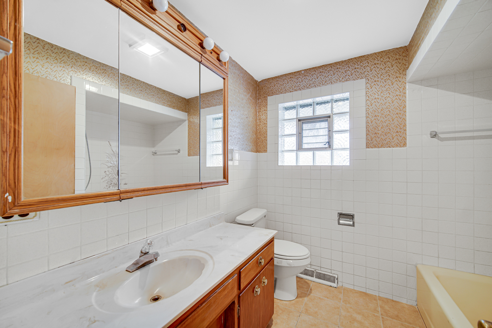 901 Oakton Street Park Ridge, IL 60068 - Photo 9 of 22 a bathroom with a sink a toilet and shower