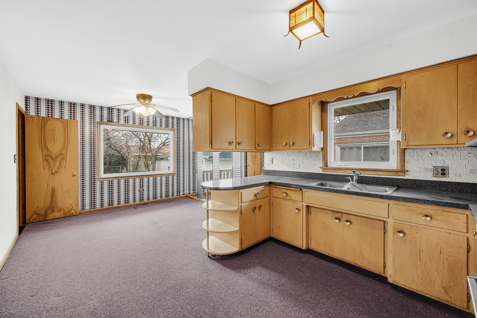 901 Oakton Street Park Ridge, IL 60068 - Photo 10 of 22 a kitchen with granite countertop a stove a sink and a window